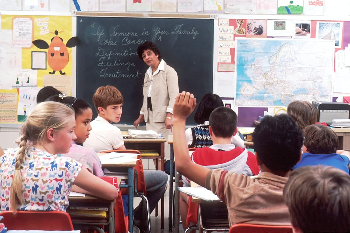 A tutor teaching a class of engaged students